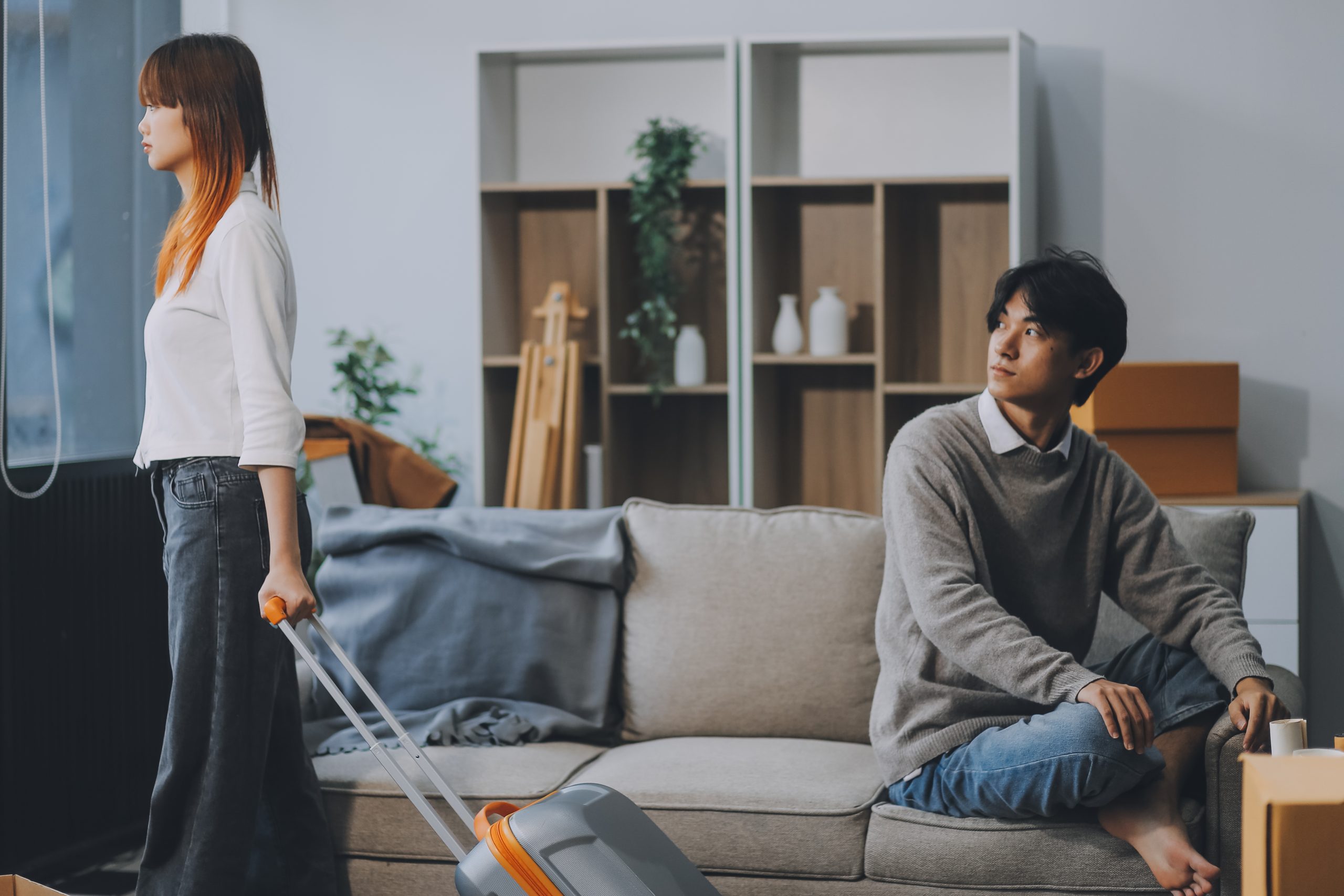 Offended couple ignoring each other after quarrel indoors, selective focus. Relationship problems